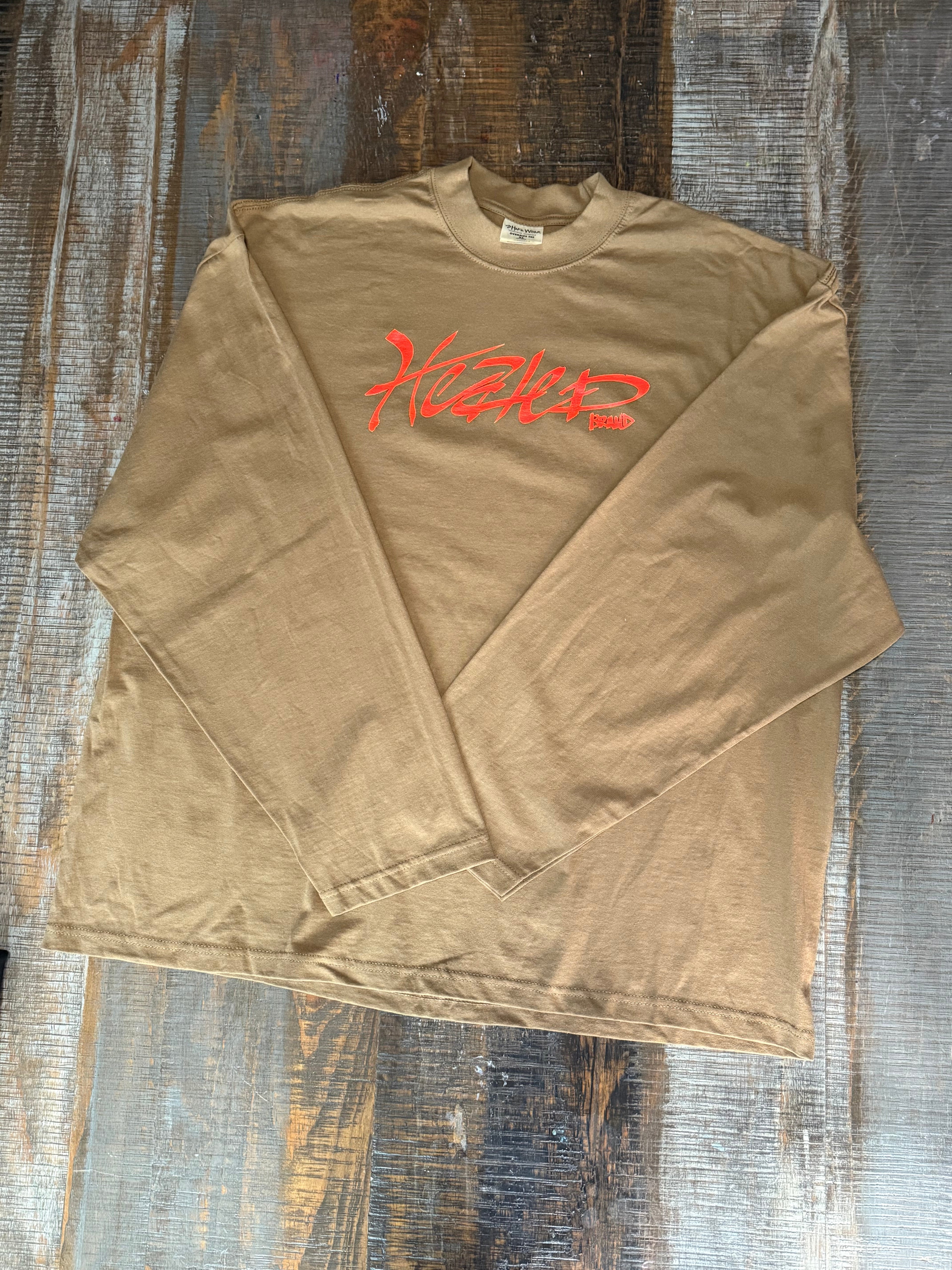 Brown t-shirt with red logo on a wooden surface